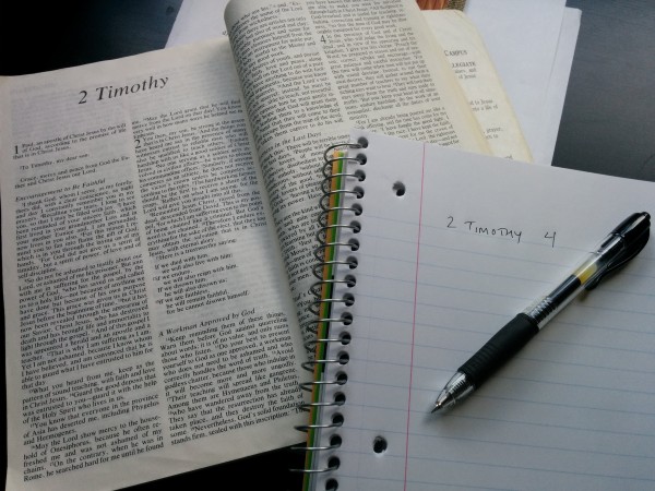 On the left, is a Bible presented in a strange form called 'print', and on the right is a quill and some parchment, which were used to record thoughts and ideas by primitive man.