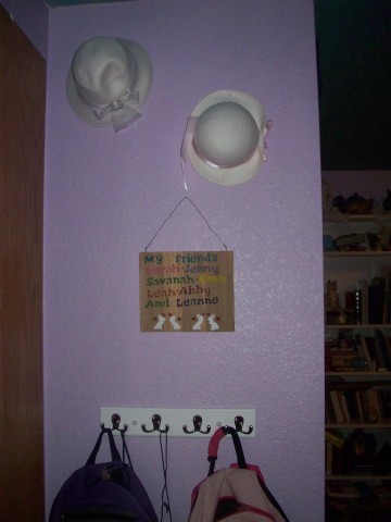 coat rack, hats and plaque