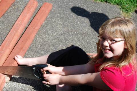 Rachel cuts boards for our raised-bed garden